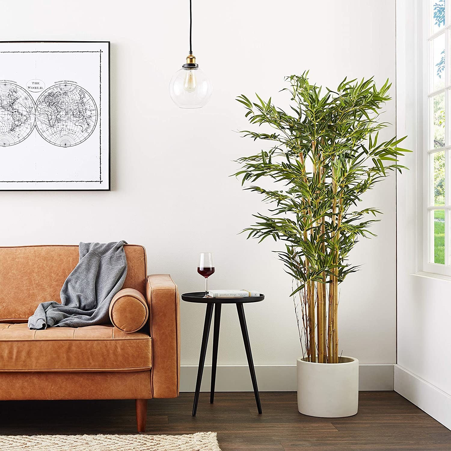 A faux bamboo tree in a white pot