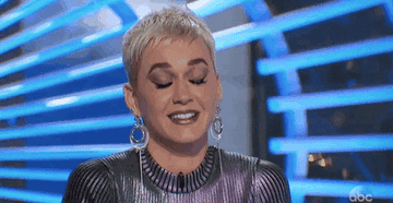 GIF featuring Katy Perry twitching one eye open and shut