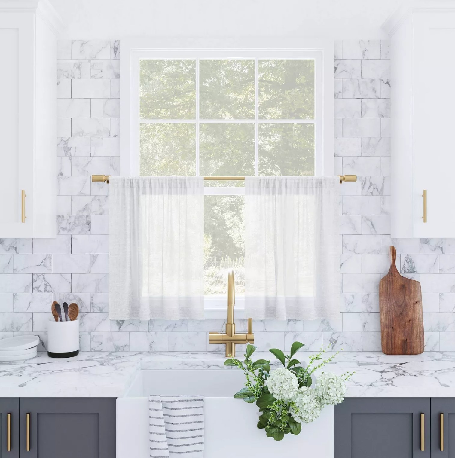 The white tiered curtains hanging in a kitchen window
