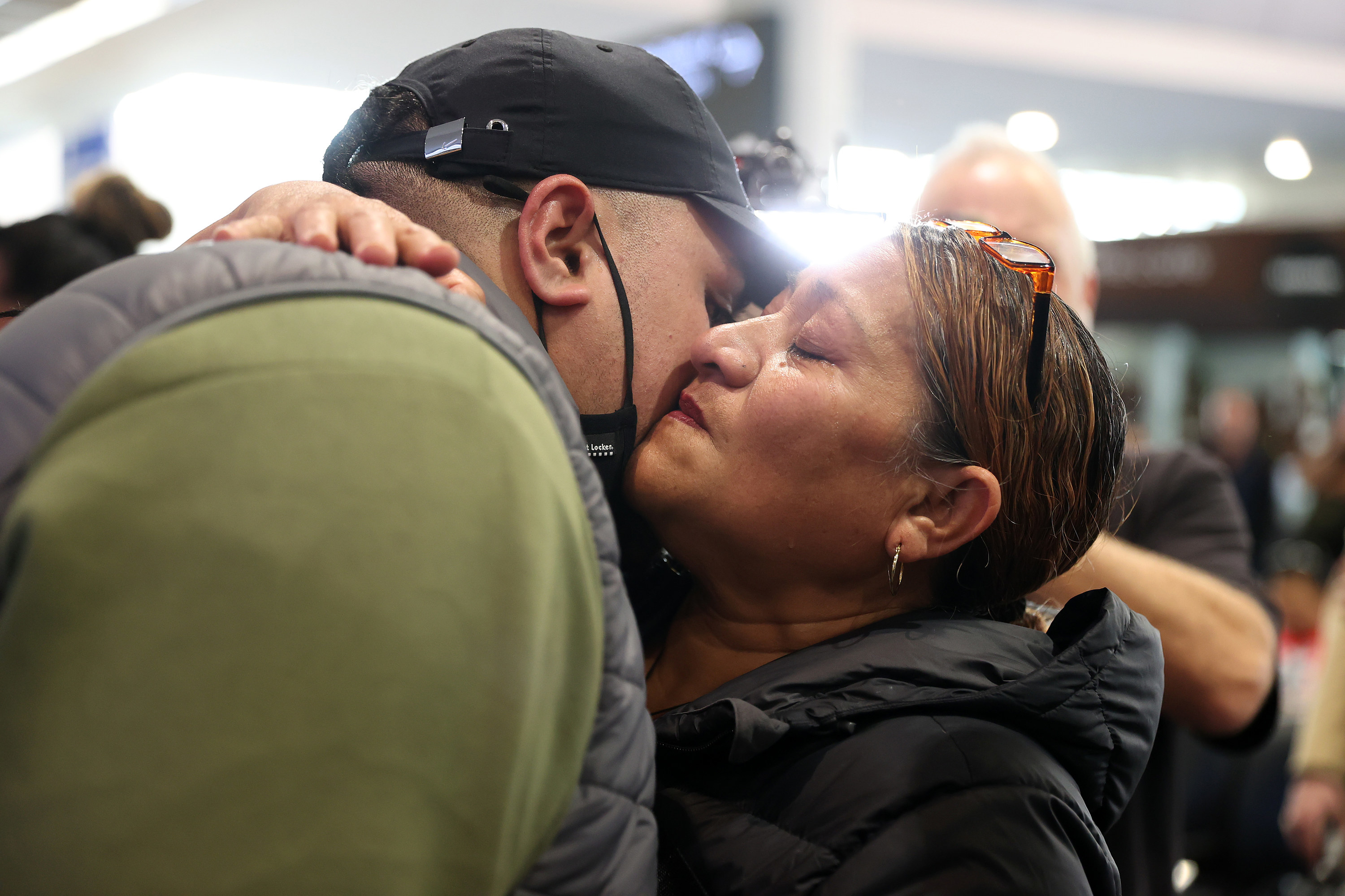 A man gives a woman a kiss on the cheek