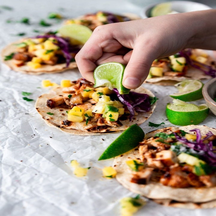 Squeezing a lime onto tacos.