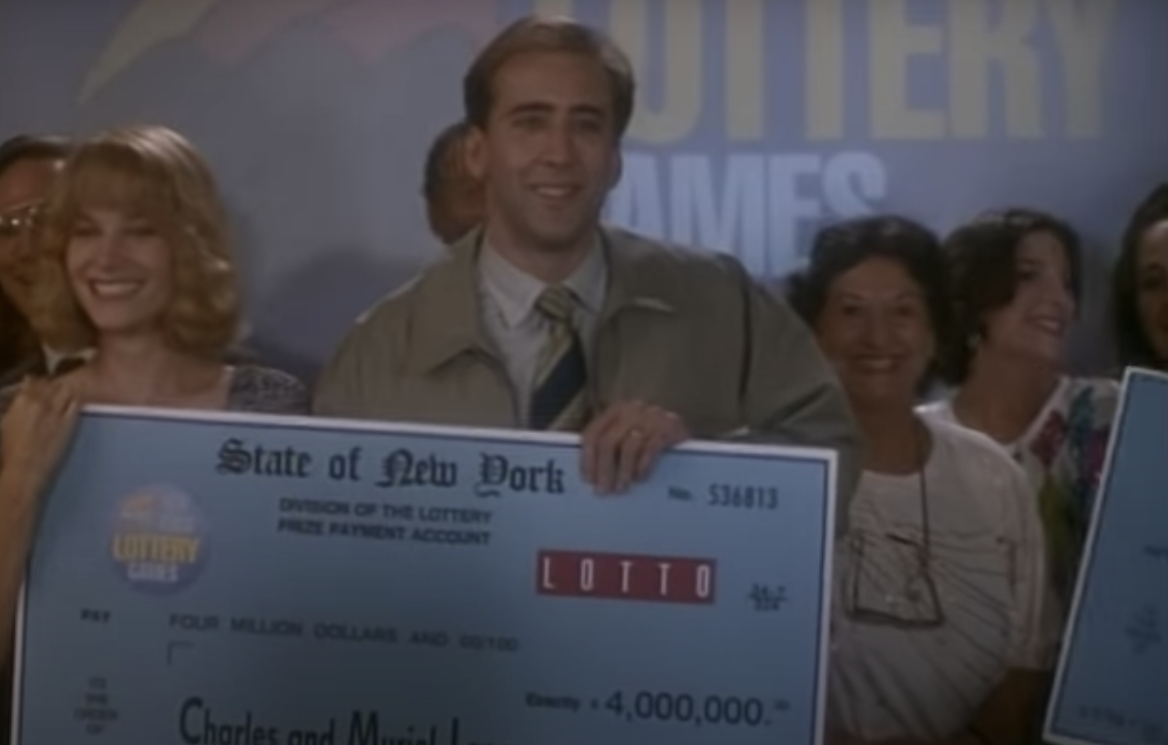 Nic Cage and Bridget Fonda holding a giant check in &quot;It Could Happen to You&quot;