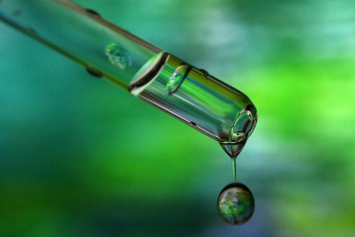 a closeup of a dropper dispensing a clear liquid