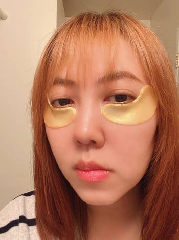 a reviewer wearing the gold eye masks