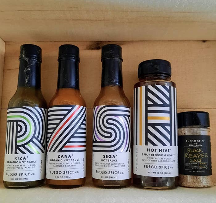 reviewer image of the gift box with hot sauces, honey, and salt
