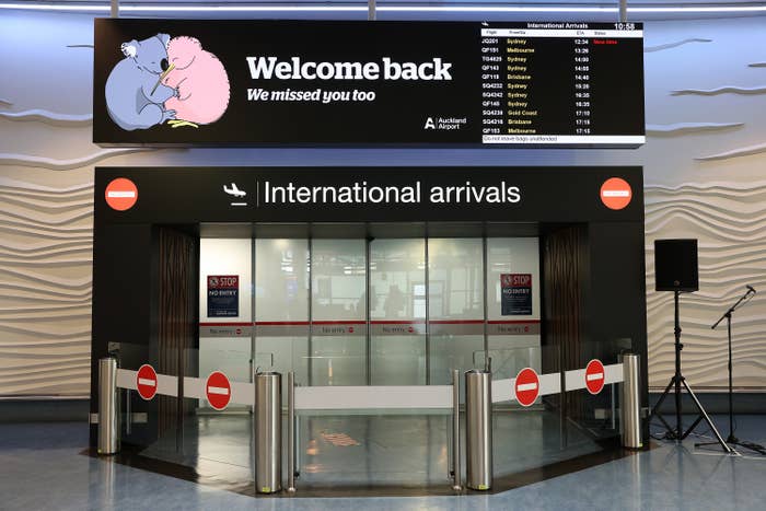 A sign over the International arrivals that says "Welcome back, we missed you too"