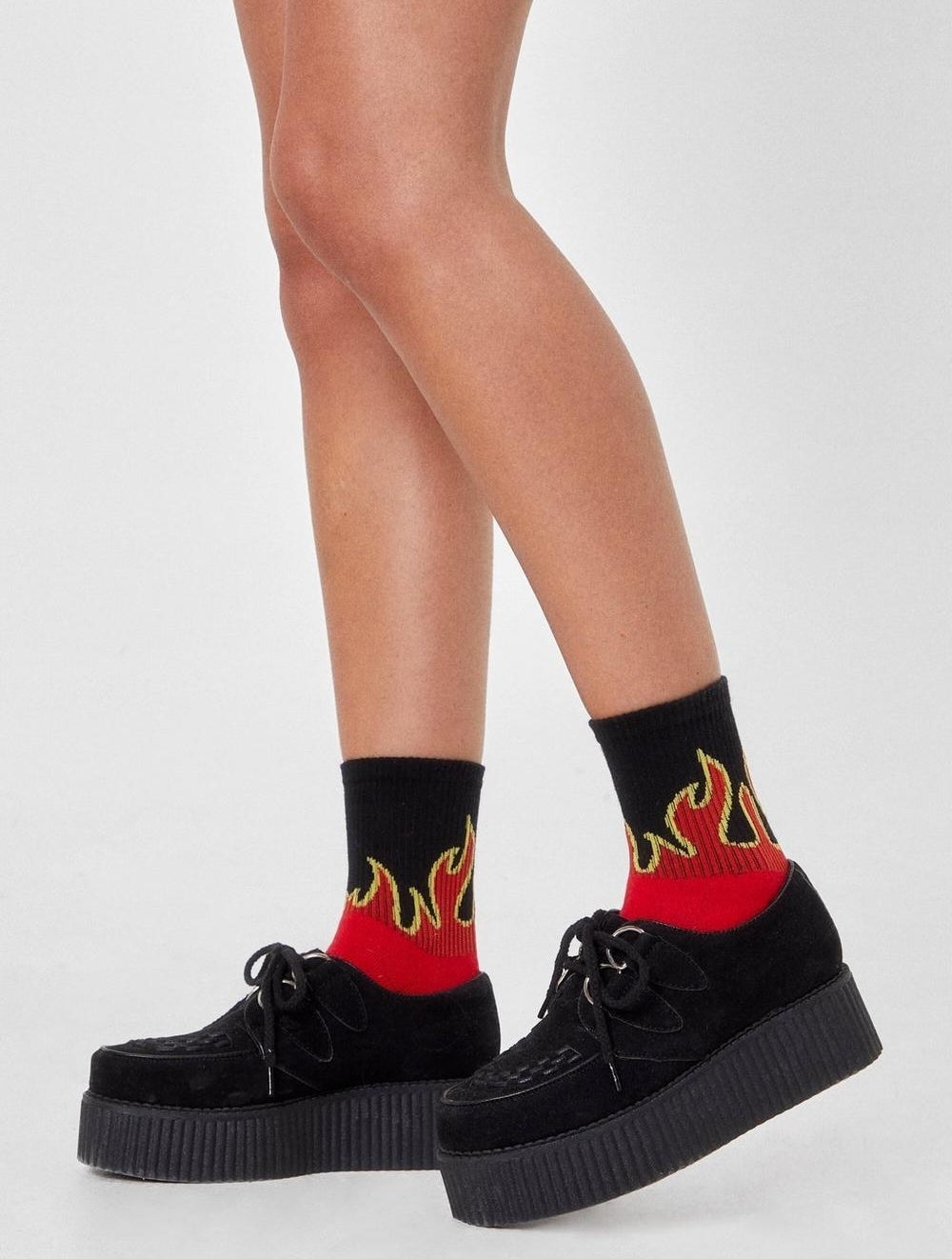 a person wearing socks with flames on them 