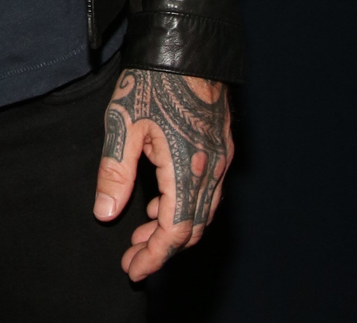 his hand is covered in tattoos