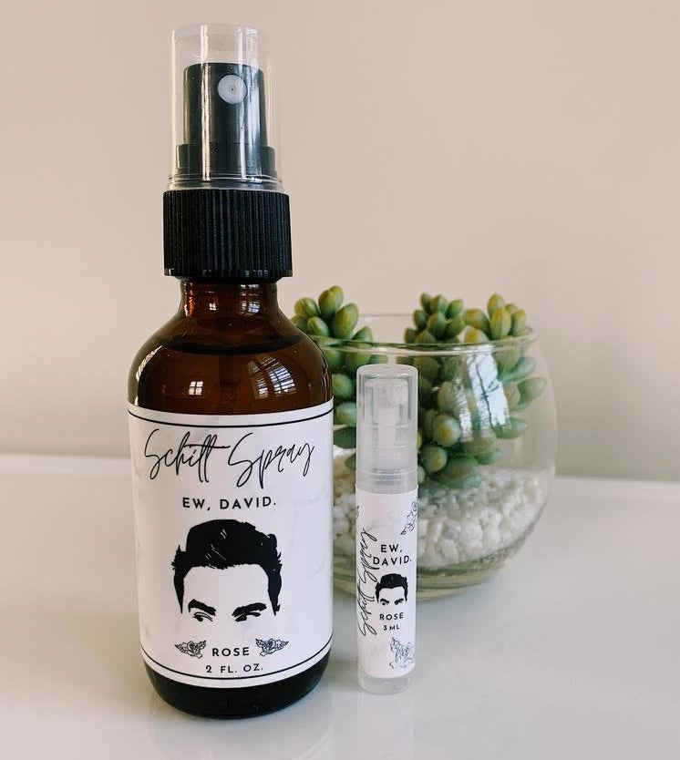 the large and small spray bottles with labels that read &quot;Schitt Spray, Ew, David&quot; with David Rose&#x27;s face on them
