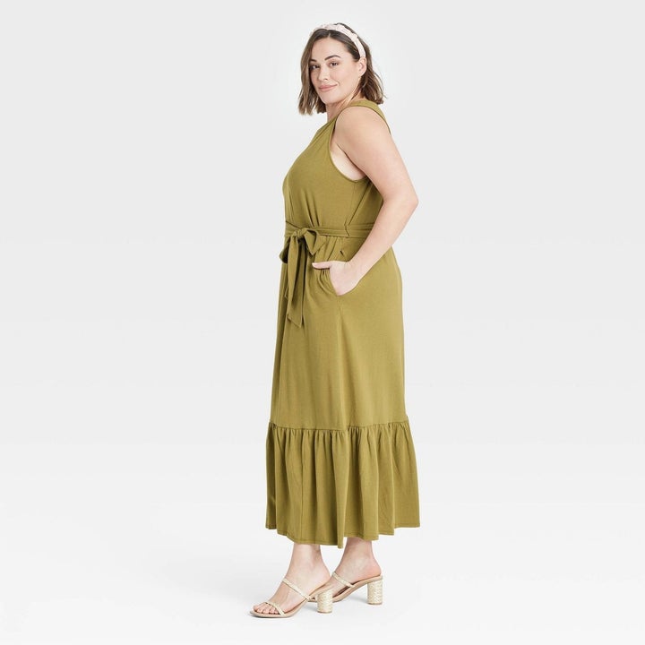 Model wearing  green maxi dress with hem skirt