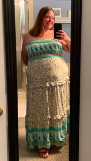 A customer review photo of them wearing the light green-colored dress