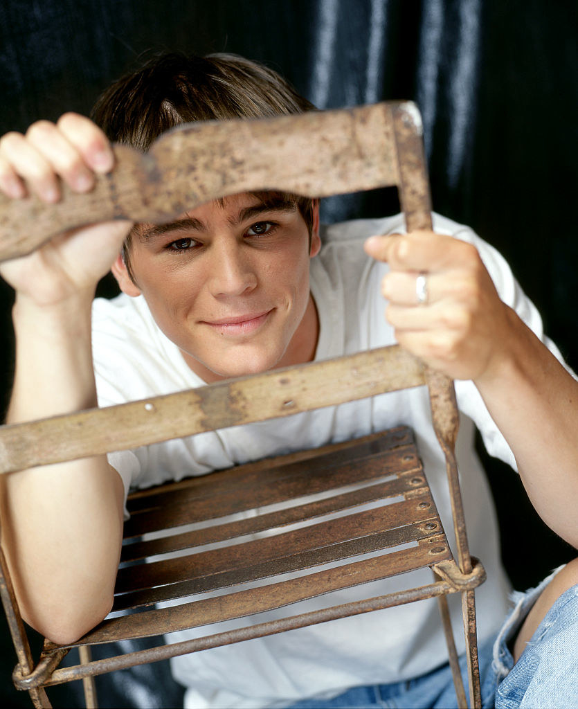 he&#x27;s looking through the opening of a chair