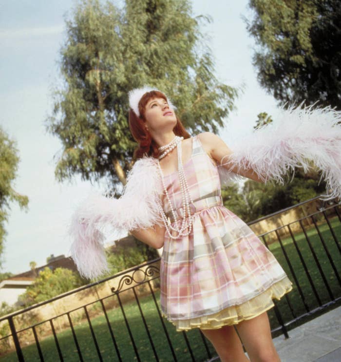 Donovan stands in front of a gate in a promo image for Clueless