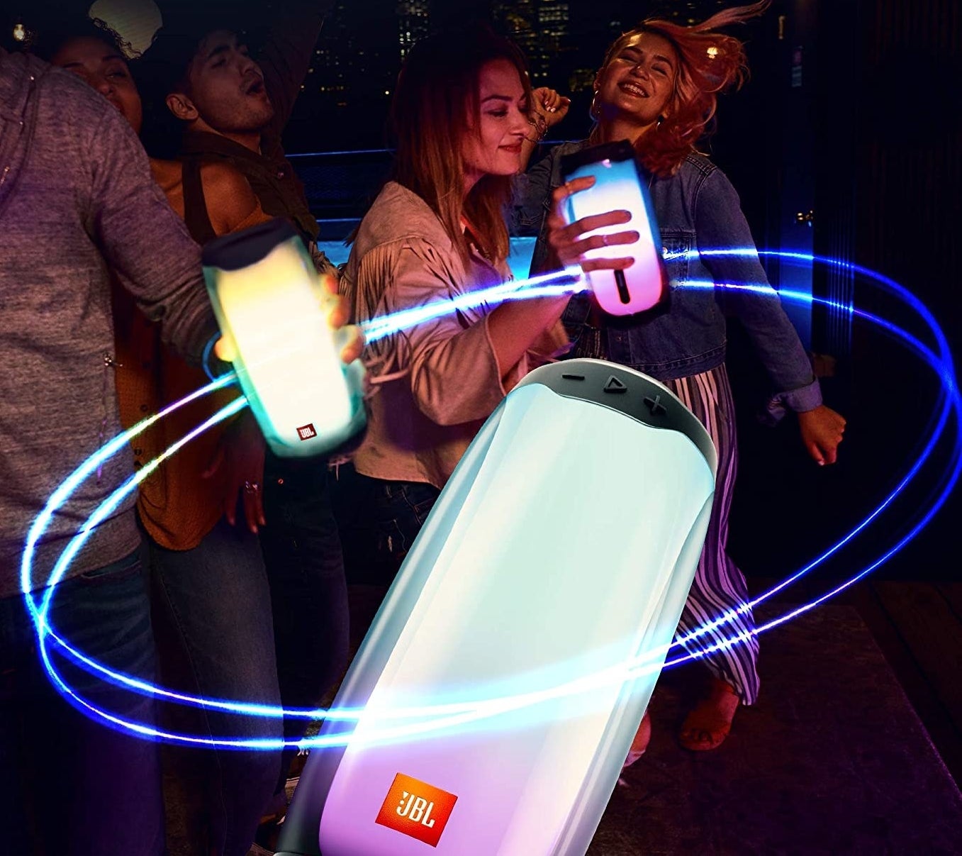 People partying while holding the speakers in their hand.