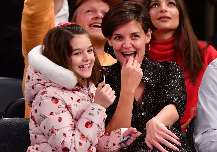 Katie and Suri share a laugh while attending a basketball game