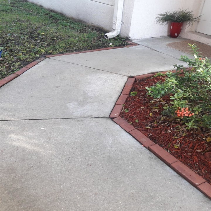 same reviewer showing the sidewalk perfectly clean after using the spray