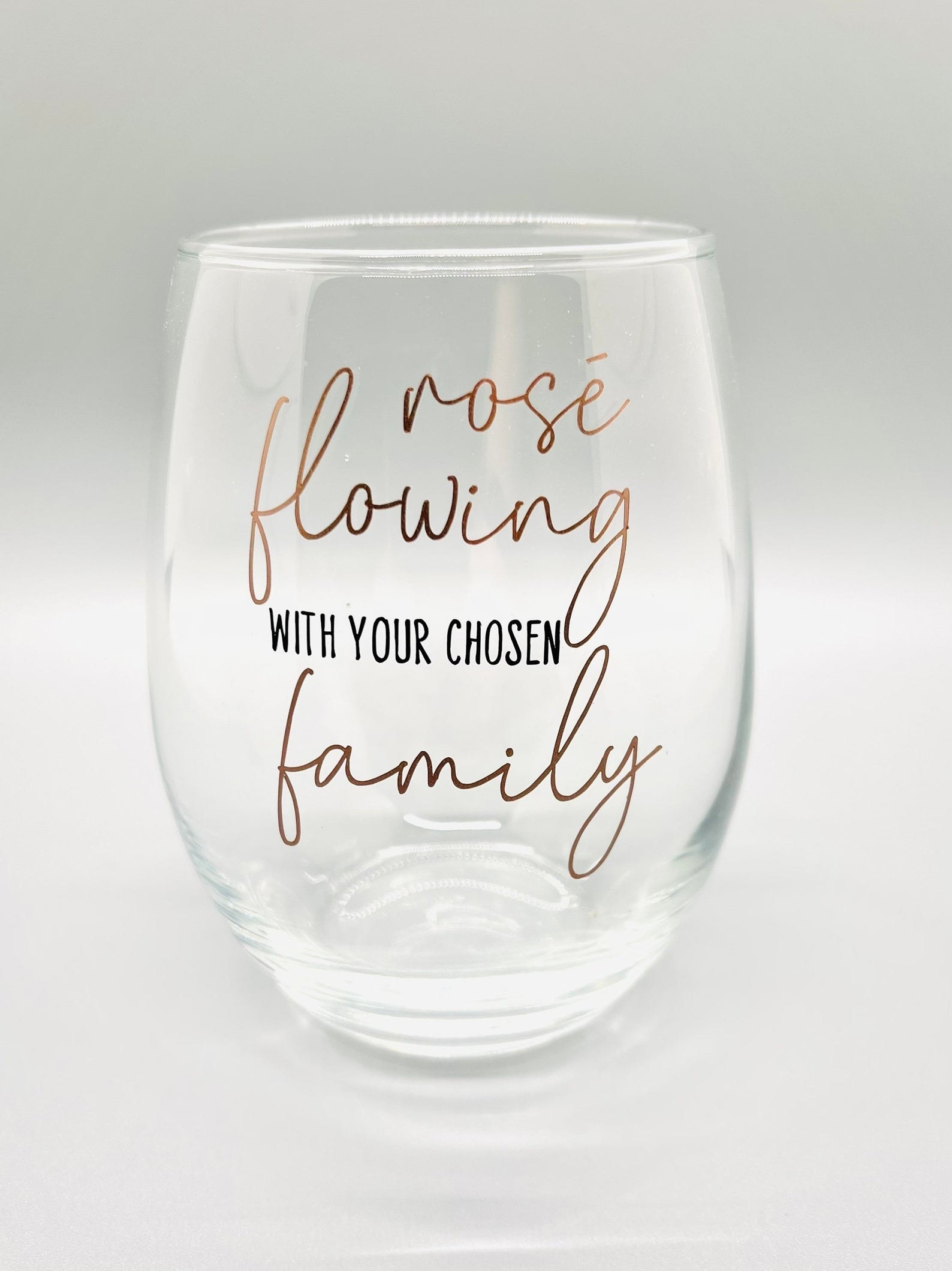 a stemless wine glass that says "rose flowing with your chosen family"