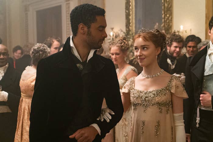 Simon and Daphne smiling at one another at a ball