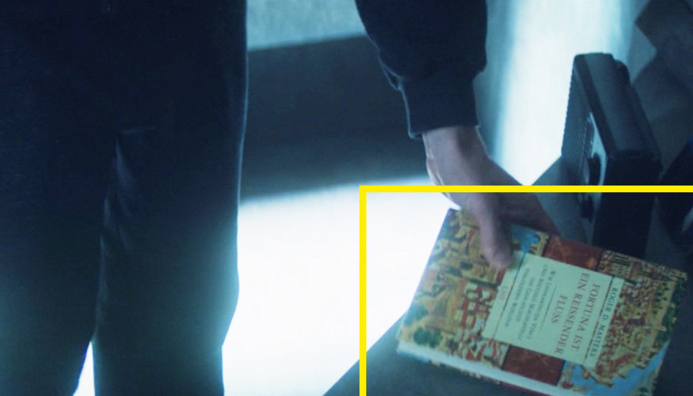 A close-up of Zemo holding his book