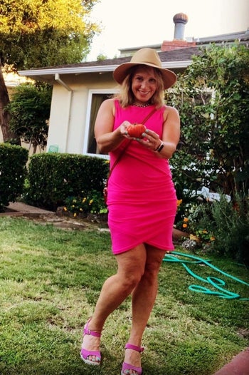 person wearing a pink t shirt dress while in a backyard
