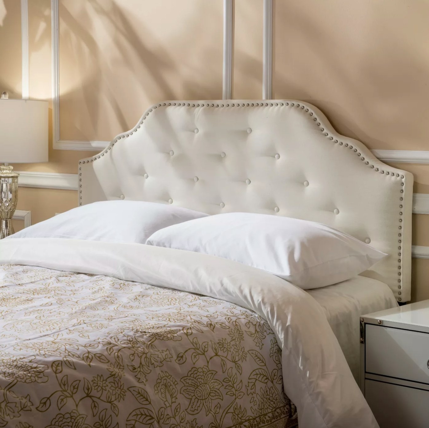 The studded headboard in ivory