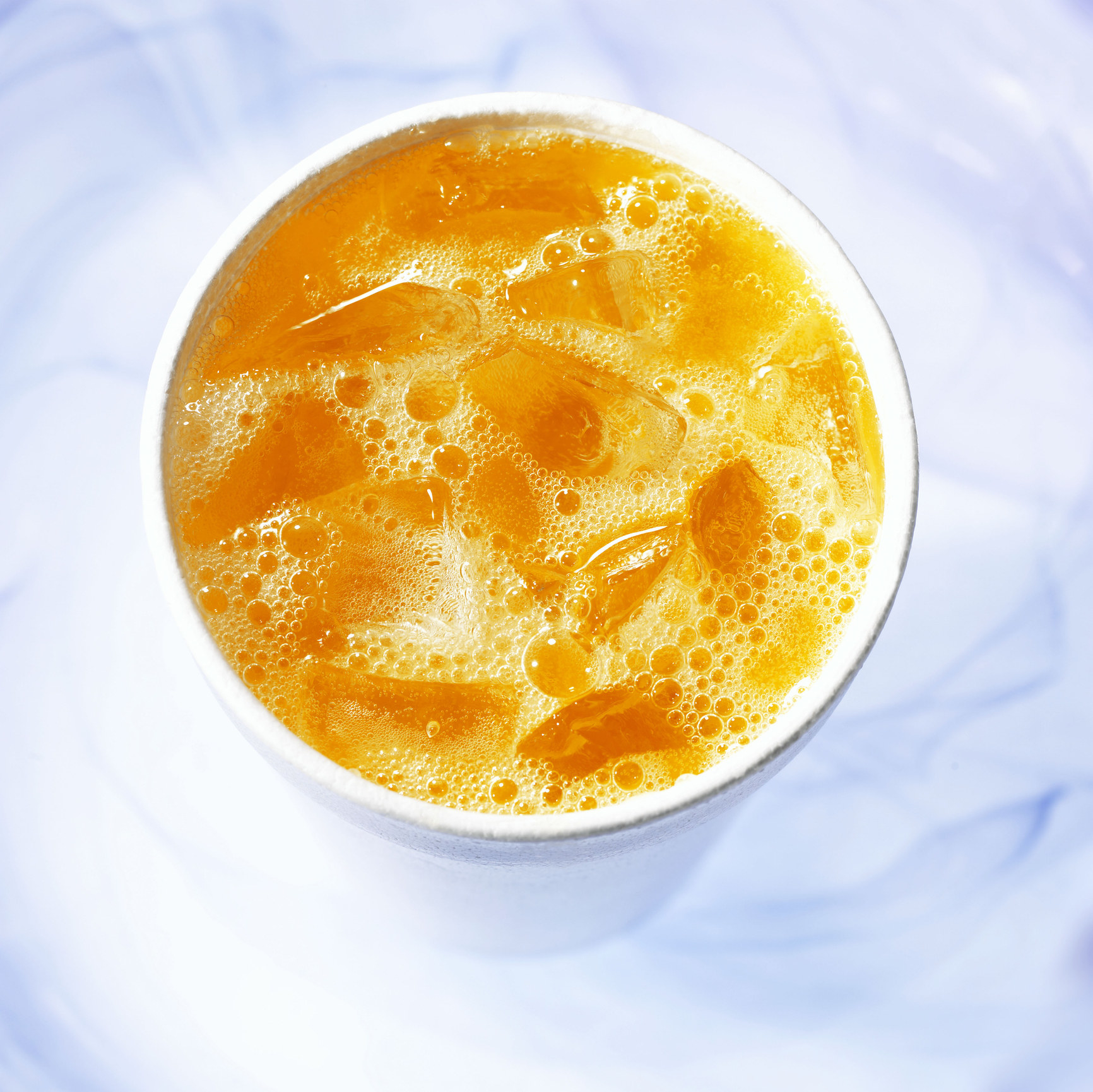 A glass of bubbly orange soda.