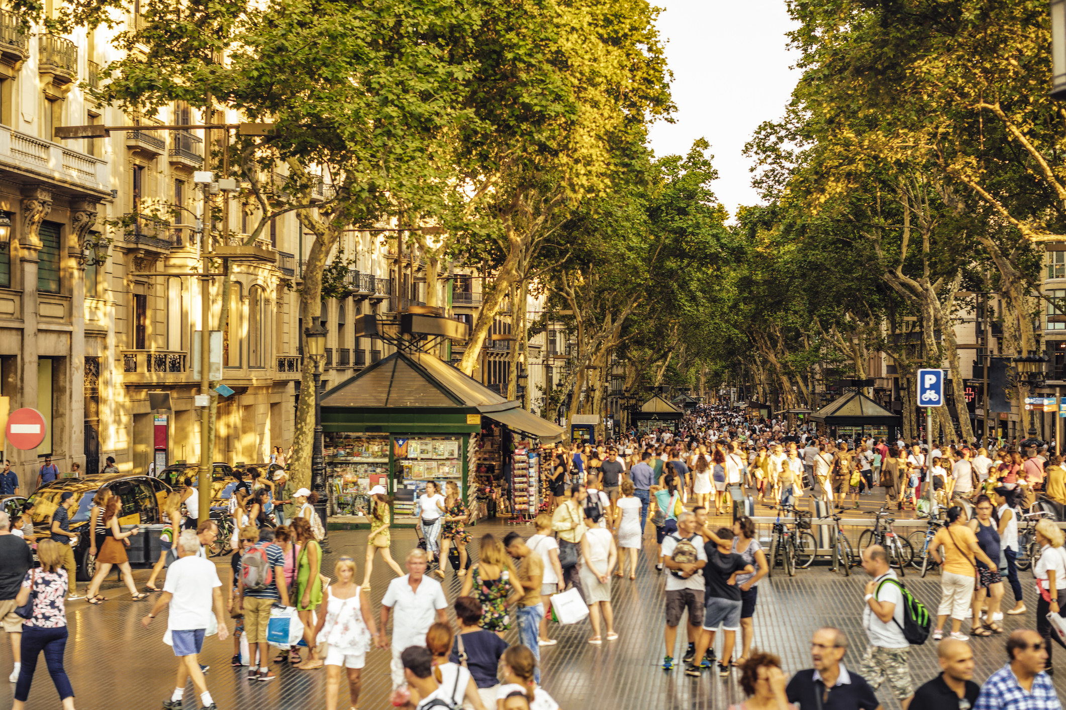 Busy crowd of people walking on La Rambla in Barcelona.