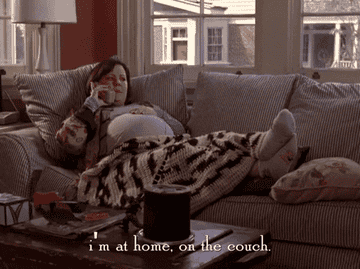 gif of Melissa McCarthy in &quot;Gilmore Girls&quot; saying &quot;I&#x27;m at home, on the couch&quot; 