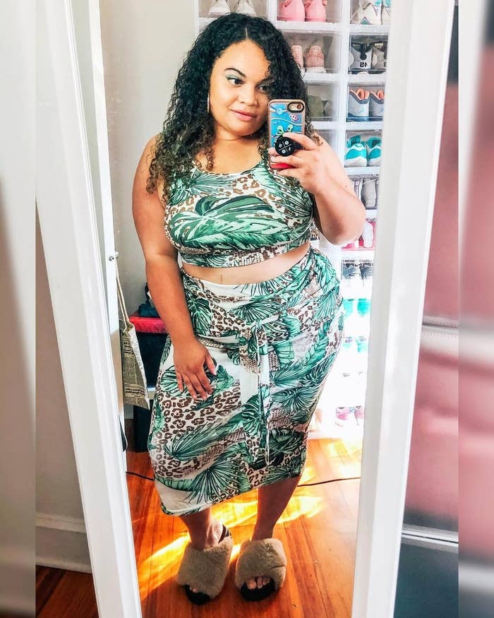 buzzfeed editor wearing the two-piece crop top and midi skirt set in a green and brown jungle print 