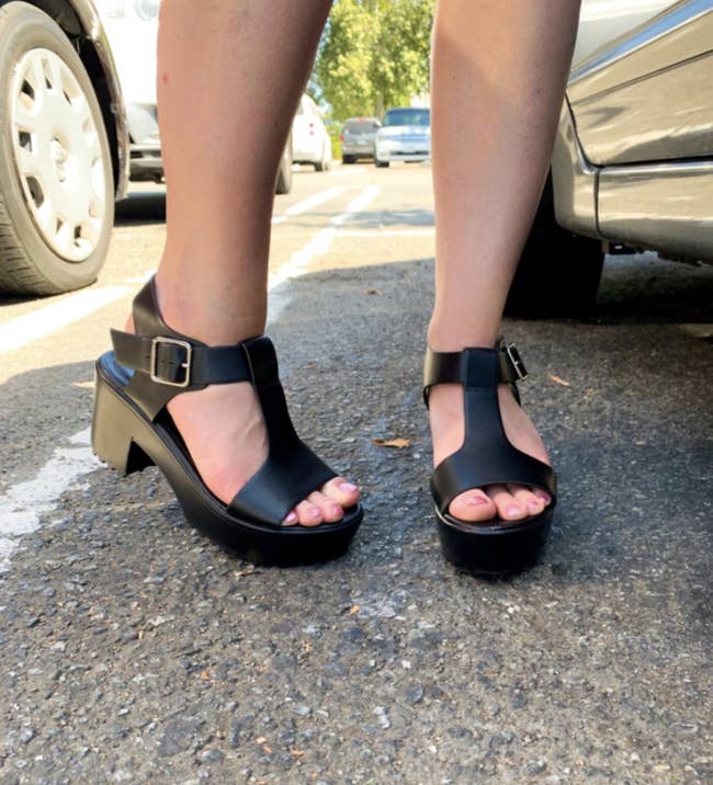 reviewer wearing the chunky sandals with a T-strap and ankle straps
