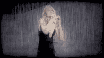 Taylor performing in the rain on stage