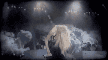 Taylor flipping her hair back on stage