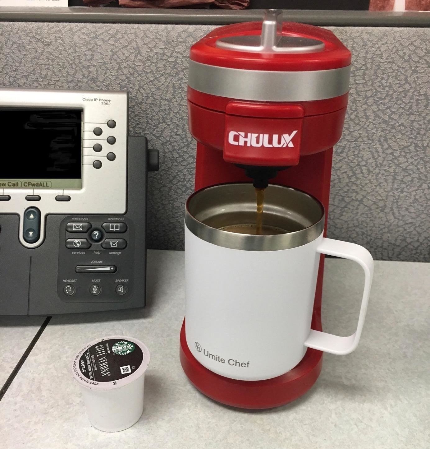 reviewer photo showing their red coffee maker fits right on their desk 