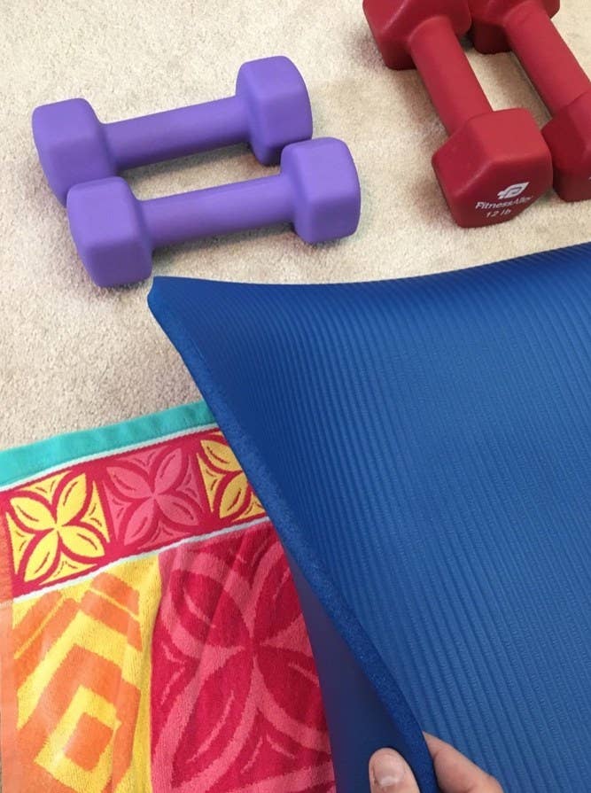 A blue yoga mat with a set up in a reviewer&#x27;s home