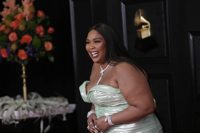Lizzo on the Grammys red carpet in a sweetheart strapless gown, diamond necklace, and diamond bracelets