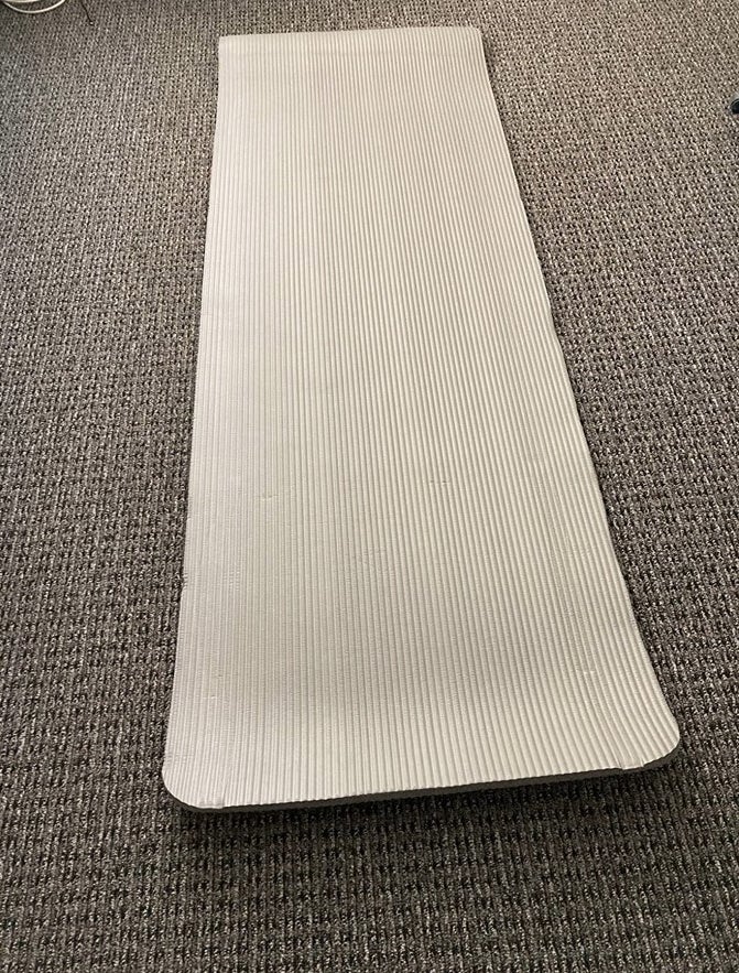A grey yoga mat in a reviewer&#x27;s home