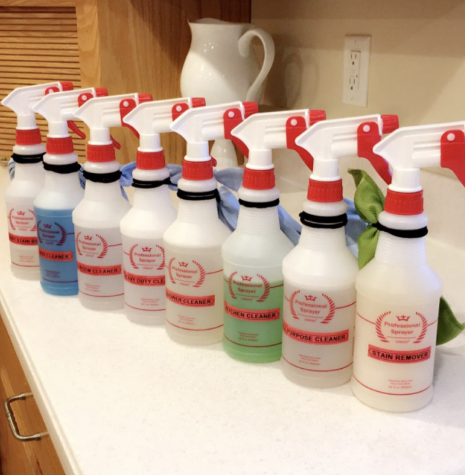 a reviewer&#x27;s bottles with cleaning solutions