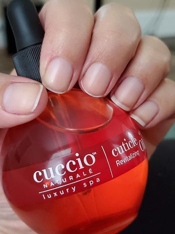 a different reviewer holding the pomegranate cuticle oil