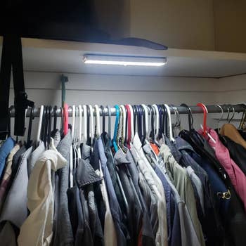 a reviewer photo of a closet with one of the light installed under the shelf 
