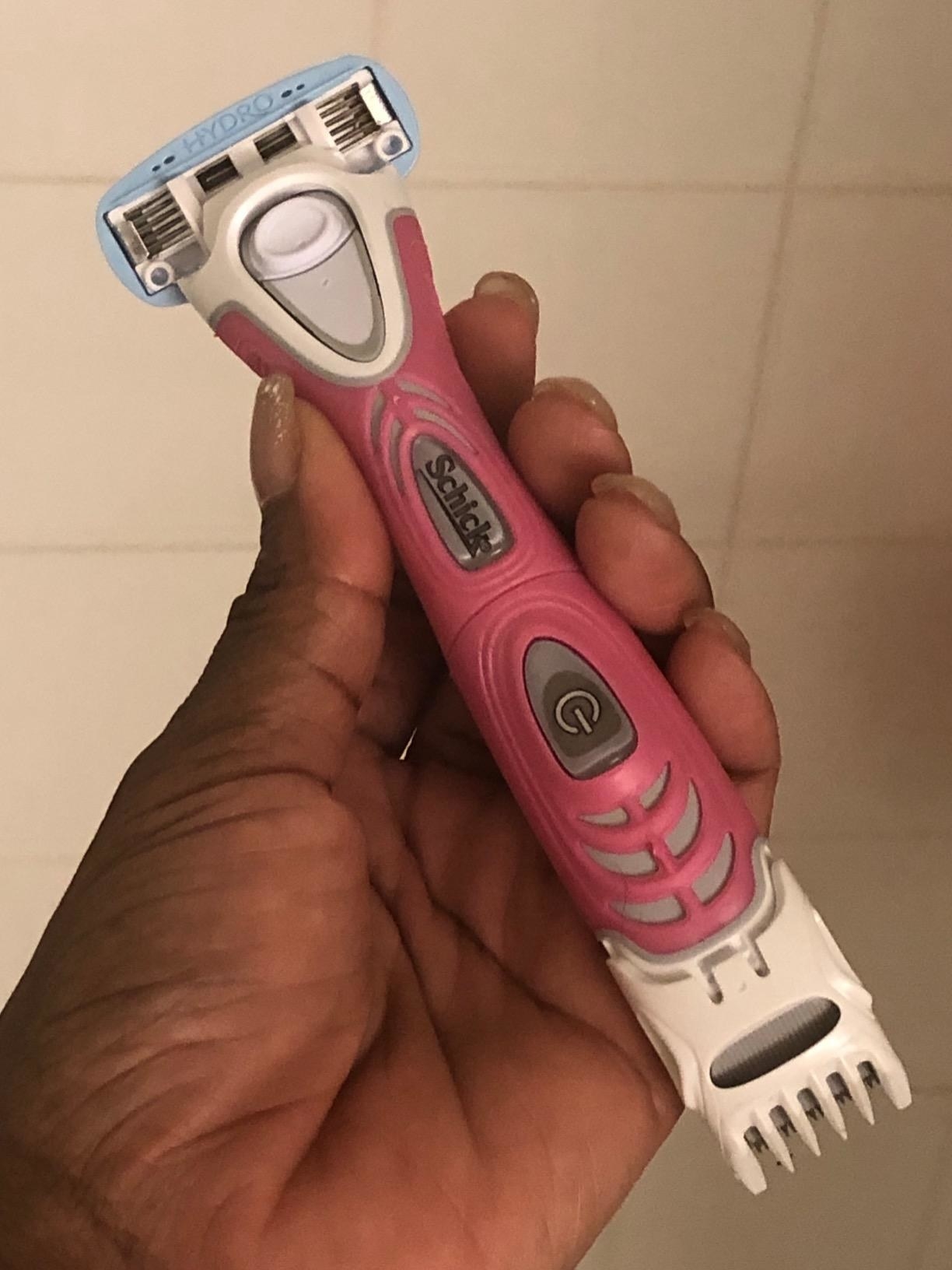 reviewer holding the pink double-ended razor