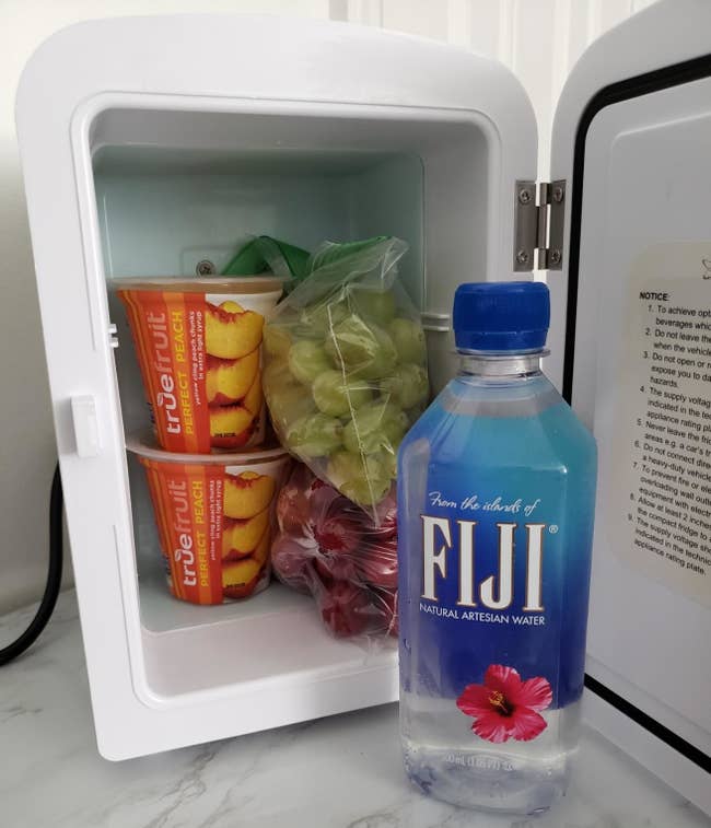 water and some snacks in the fridge