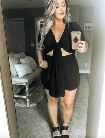 reviewer wearing the black cutout romper