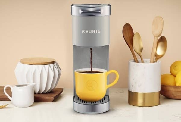 The coffee maker, which is narrow, with space for your cup