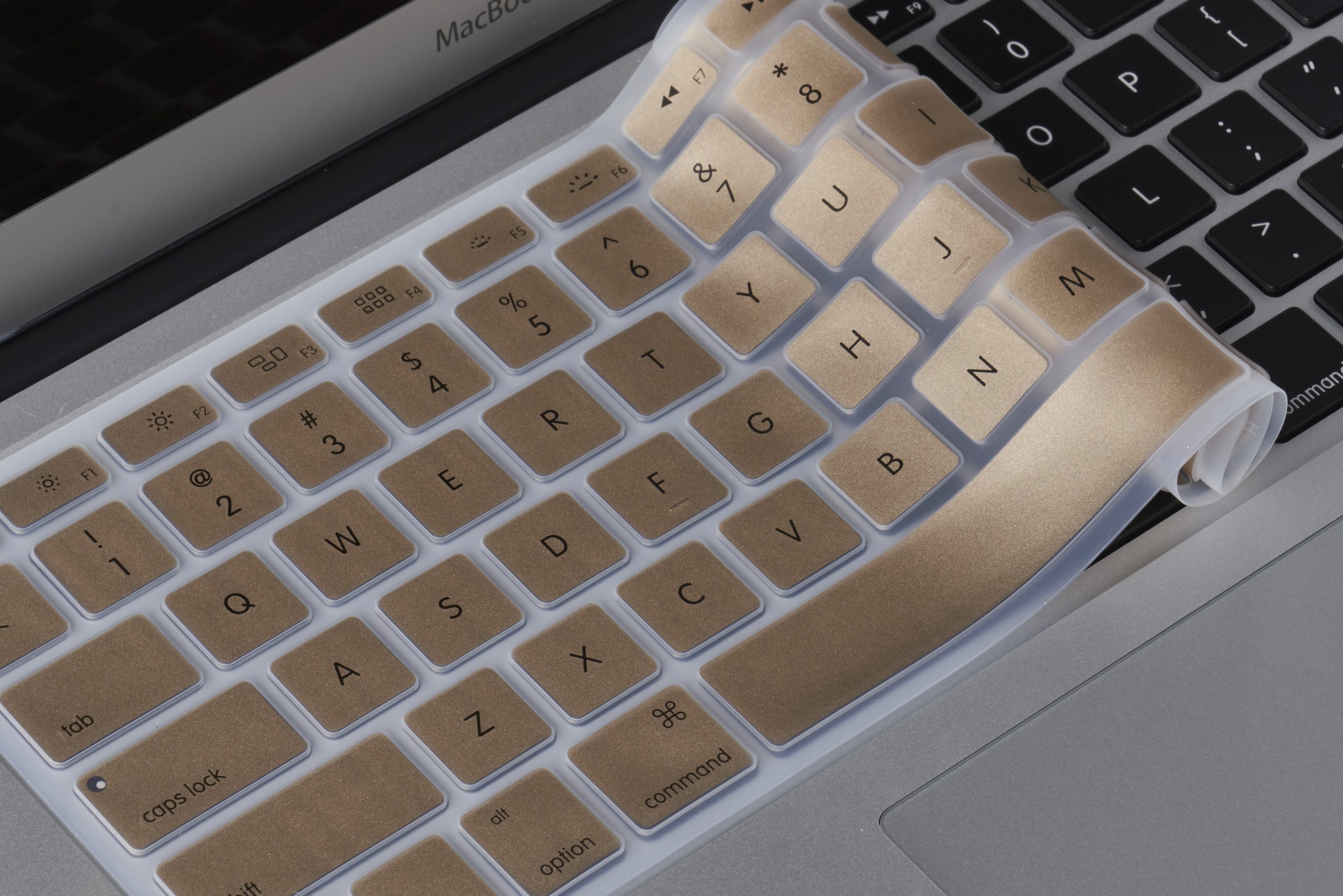 Gold silicone keyboard cover on laptop