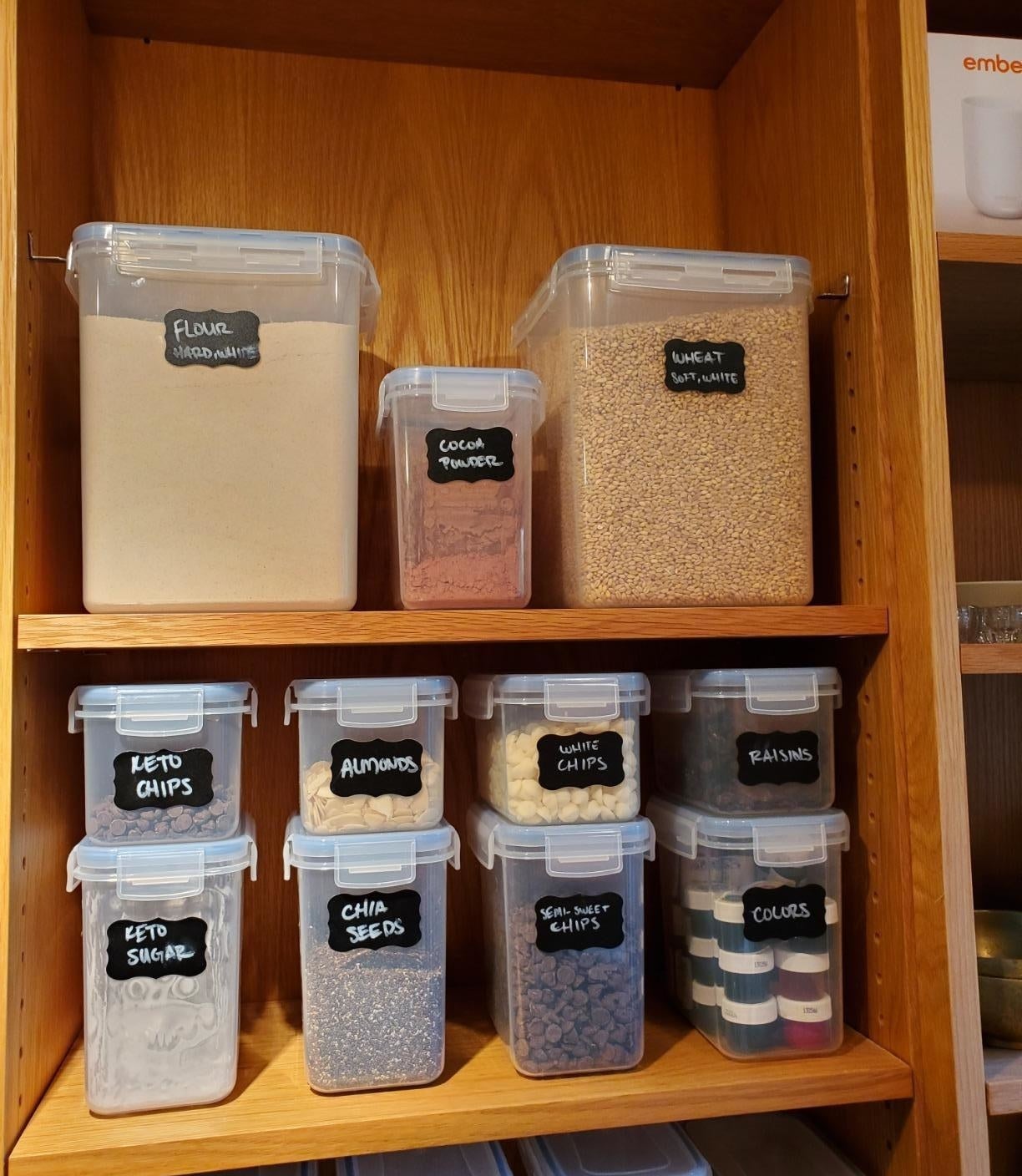 reviewer image of the full 15 piece Airtight Food Storage Containers Set in a cabinet being used to store different kinds of food