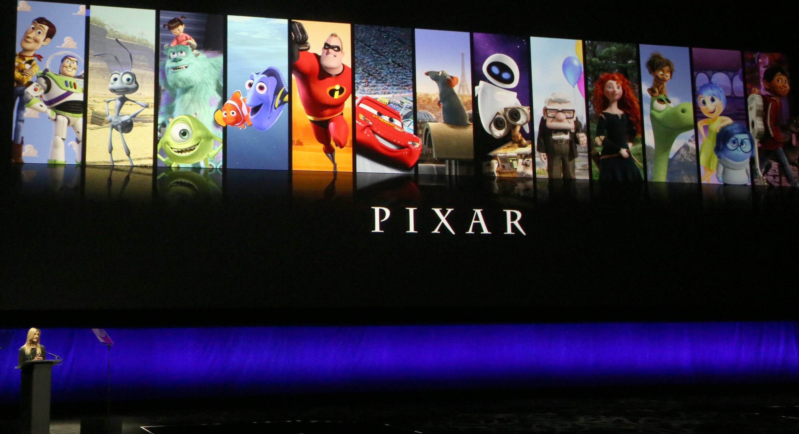 A presentation showing the title &#x27;Pixar&#x27; with vertical banners of different Pixar movies, including Toy Story, Monsters Inc, and the Incredibles