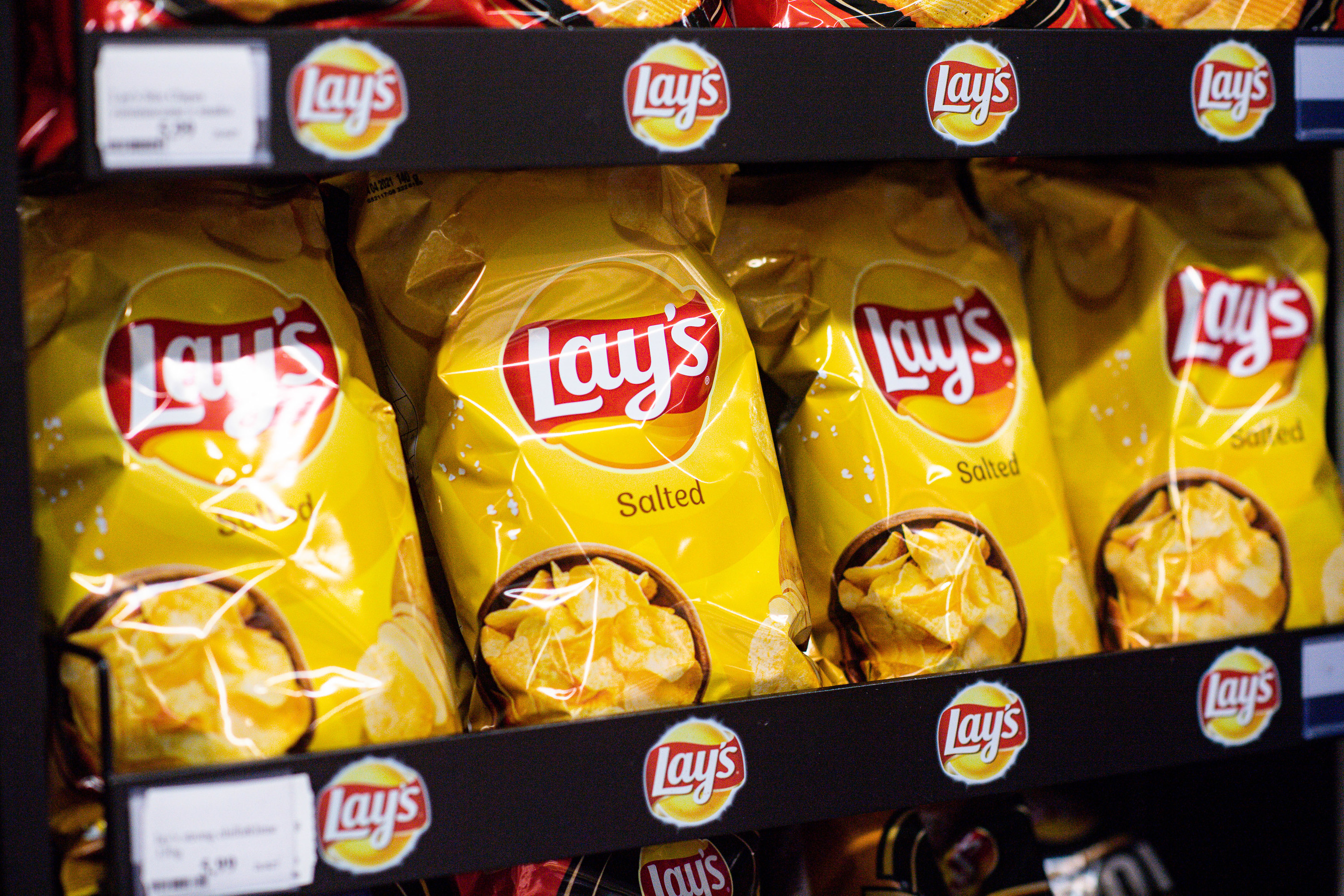 A shelf of Lay&#x27;s chips in a store