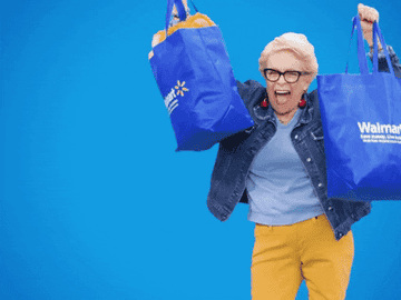 Model dancing while holding Walmart bags filled with items