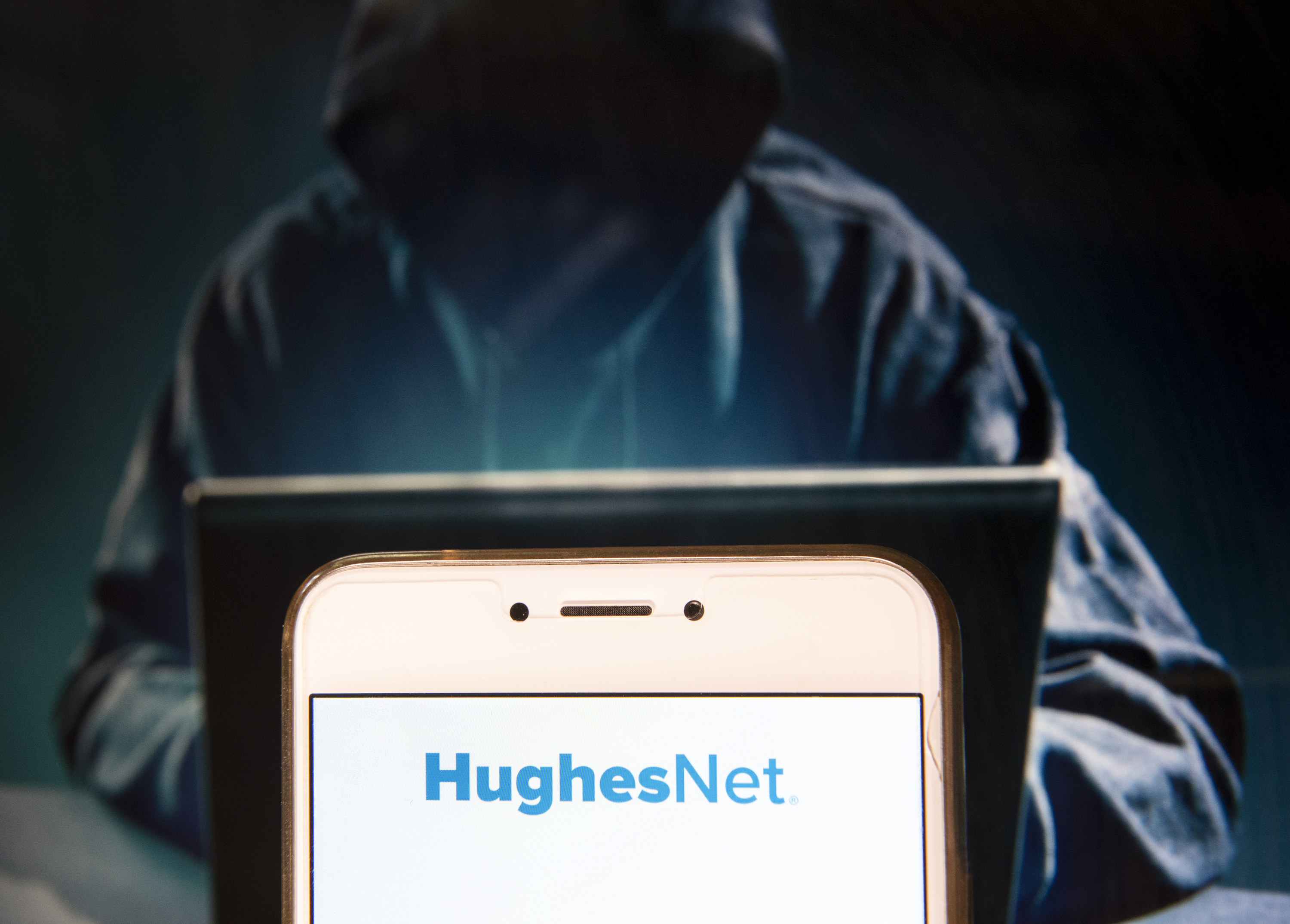 The HughesNet logo on a smartphone