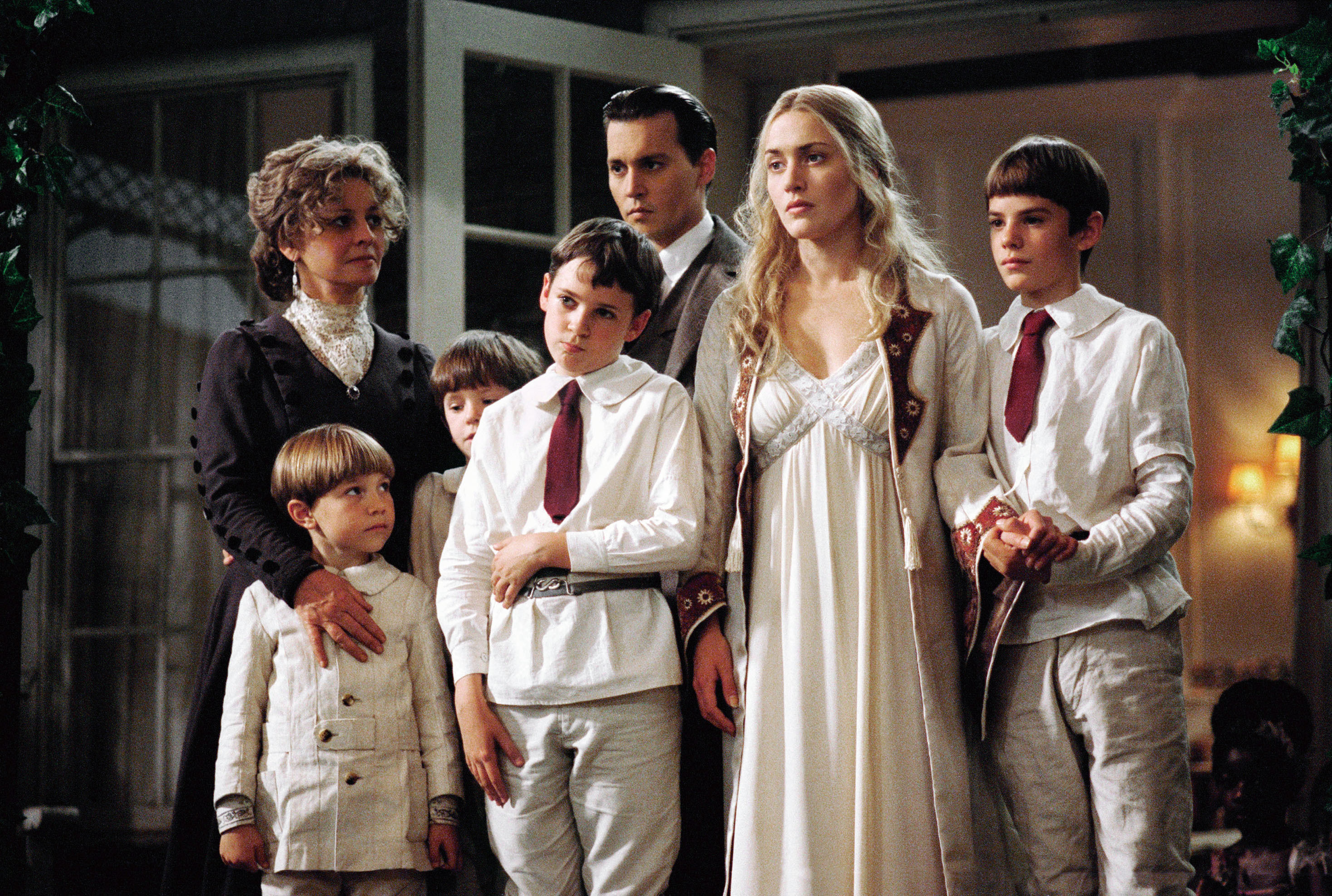 Kate wearing a white gown and standing with Johnny Depp and children